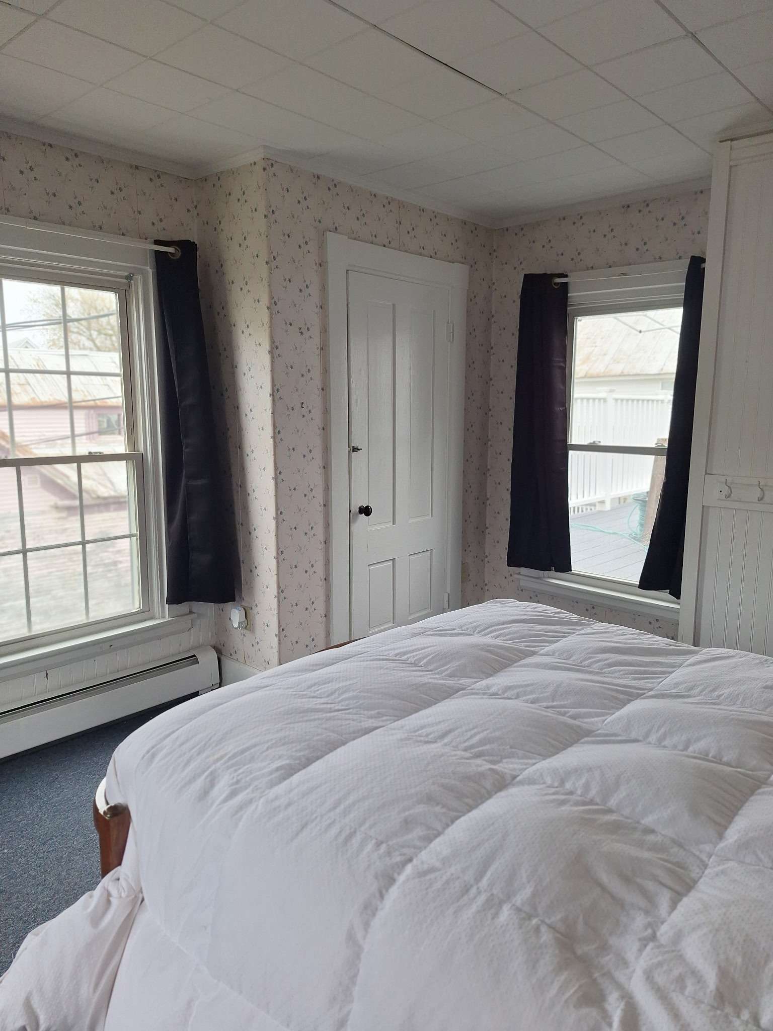 Bedroom with natural light and two windows in Skowhegan rental - perfect for contractors