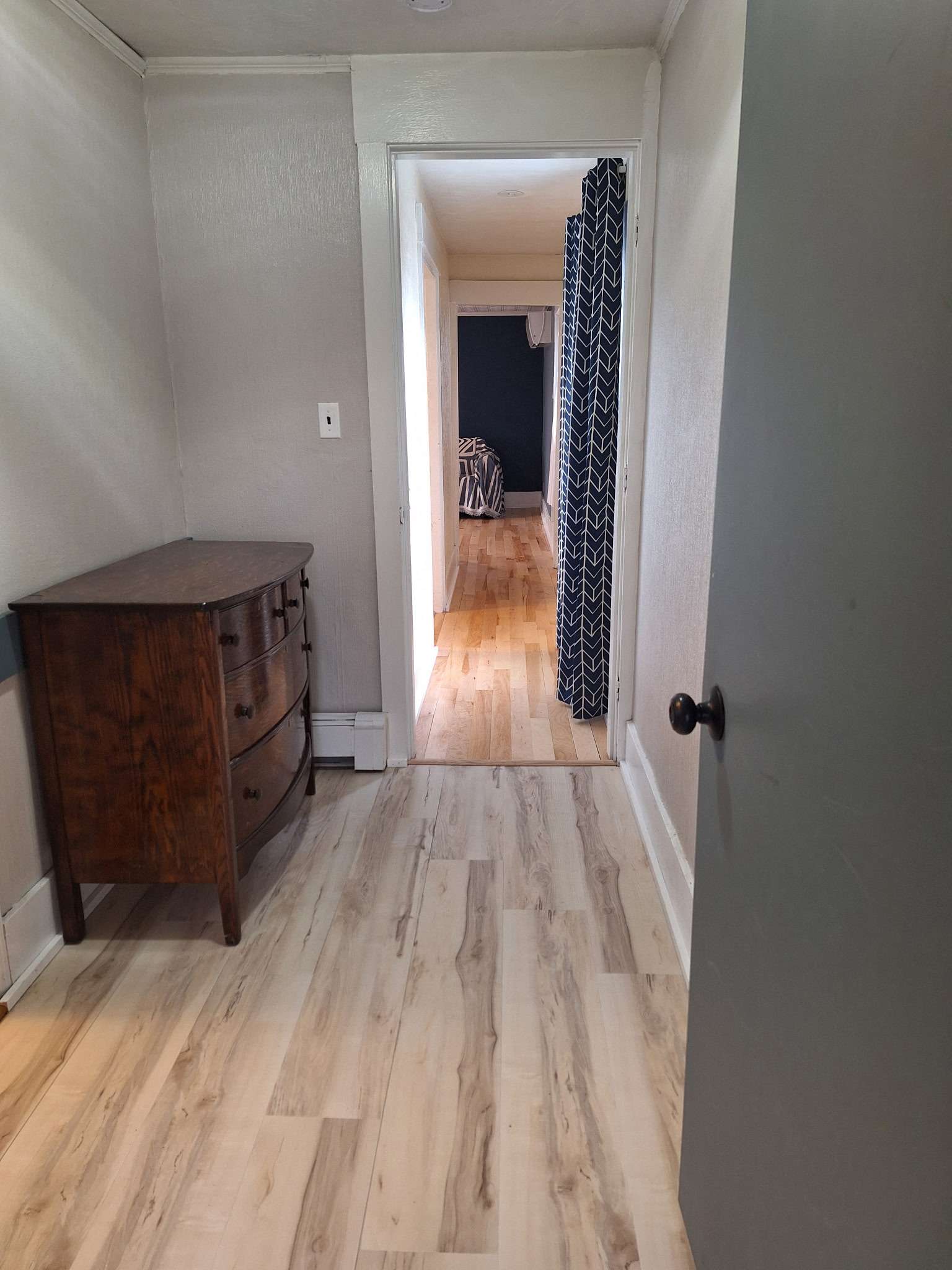 Hallway with antique dresser and modern flooring in Skowhegan contractor rental