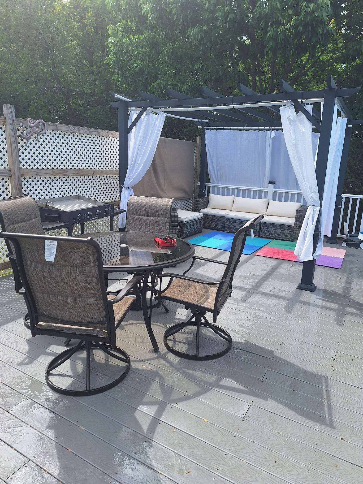 Outdoor deck with pergola, dining area and comfortable seating in Skowhegan contractor housing